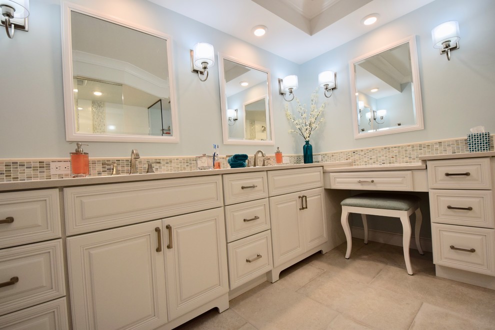 This is an example of a large transitional master bathroom in Other with raised-panel cabinets, white cabinets, an open shower, a two-piece toilet, beige tile, ceramic tile, blue walls, ceramic floors, an undermount sink, engineered quartz benchtops, beige floor, an open shower and beige benchtops.