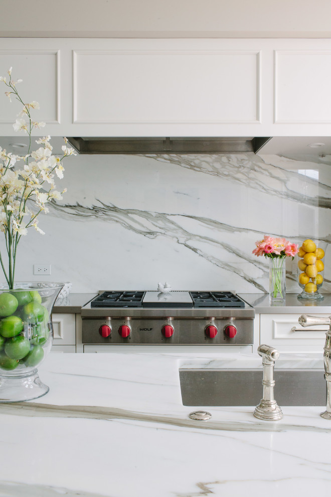 Eat-in kitchen - large transitional galley dark wood floor eat-in kitchen idea in Chicago with an undermount sink, beaded inset cabinets, white cabinets, marble countertops, white backsplash, stone slab backsplash, stainless steel appliances and an island