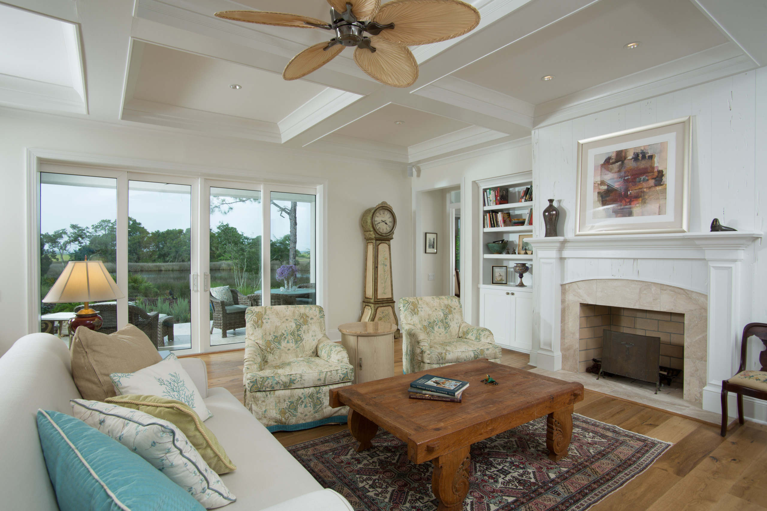 Example of a large classic formal and open concept medium tone wood floor and brown floor living room design in Jacksonville with beige walls, a standard fireplace, a stone fireplace and no tv