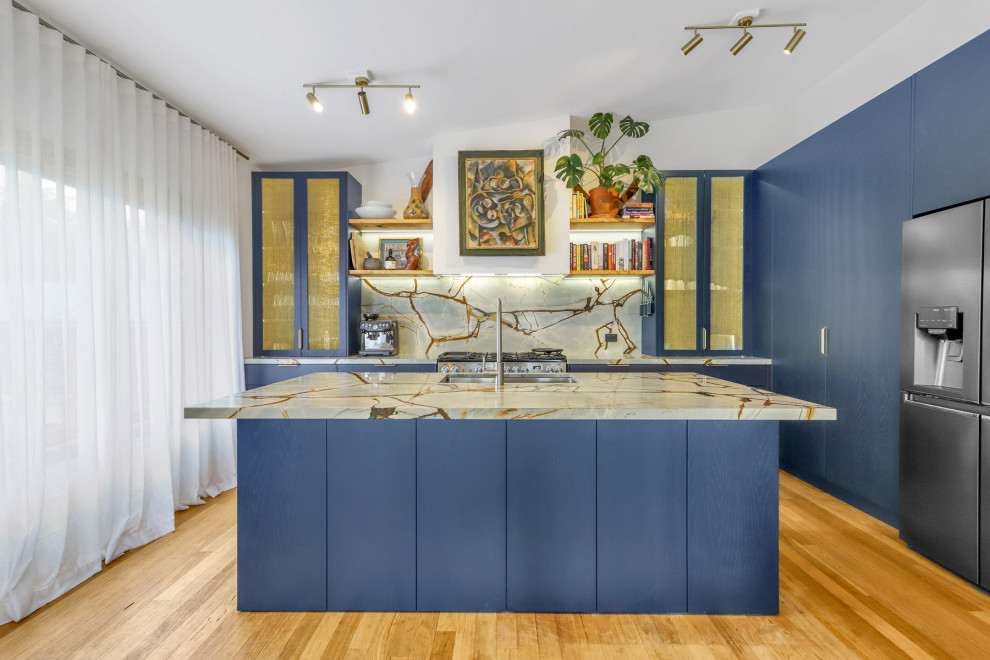 Design ideas for a large contemporary l-shaped eat-in kitchen in Sydney with an undermount sink, blue cabinets, quartzite benchtops, multi-coloured splashback, stone slab splashback, stainless steel appliances, medium hardwood floors, with island and multi-coloured benchtop.