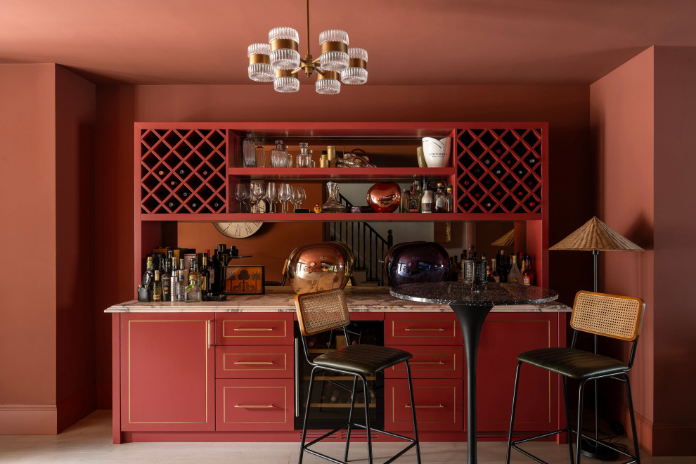 Medium sized classic single-wall home bar in London with shaker cabinets, marble worktops, mirror splashback, light hardwood flooring, white worktops and feature lighting.