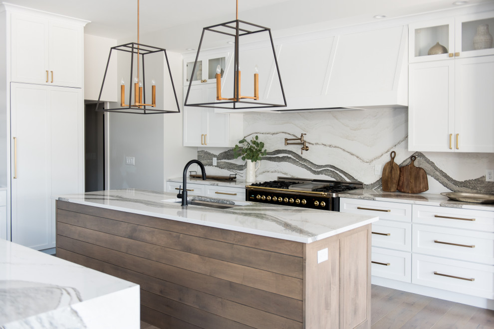 Design ideas for a mid-sized modern u-shaped open plan kitchen in Indianapolis with an undermount sink, shaker cabinets, grey cabinets, granite benchtops, stainless steel appliances, dark hardwood floors, with island and white benchtop.