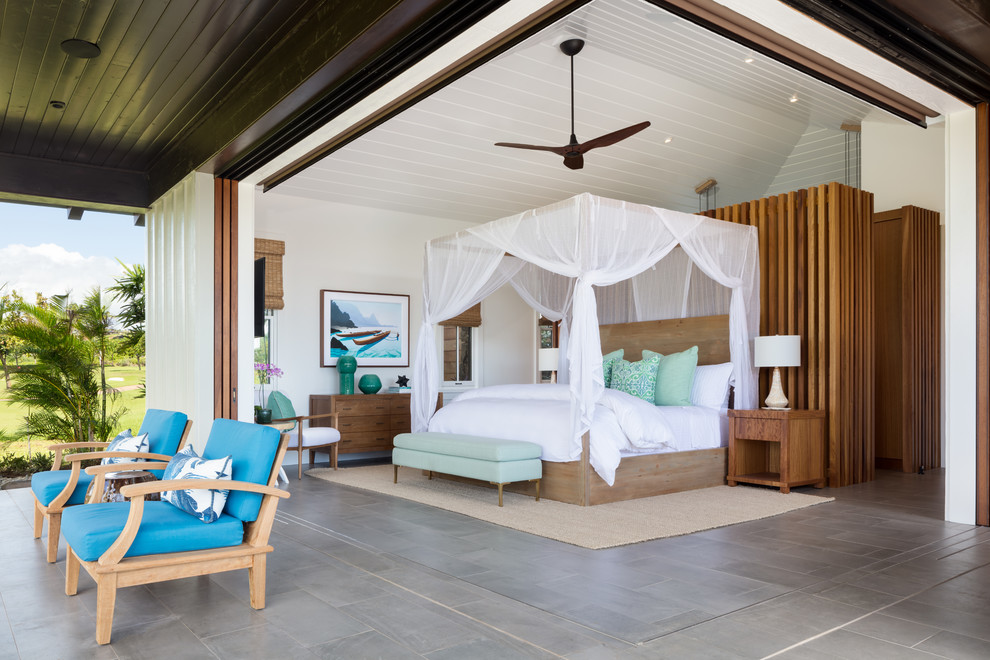 Mid-sized tropical master bedroom in Hawaii with white walls, grey floor, ceramic floors and no fireplace.