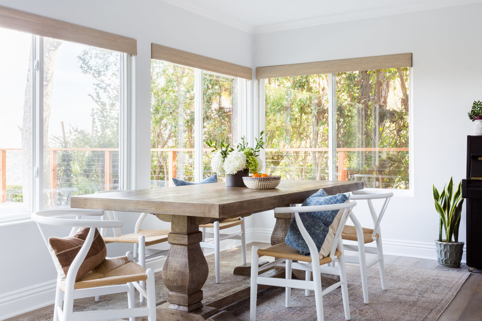 Design ideas for a beach style dining room in Los Angeles with no fireplace and white walls.