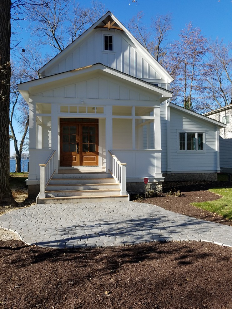 Design ideas for a country two-storey house exterior in Milwaukee with concrete fiberboard siding and a shingle roof.