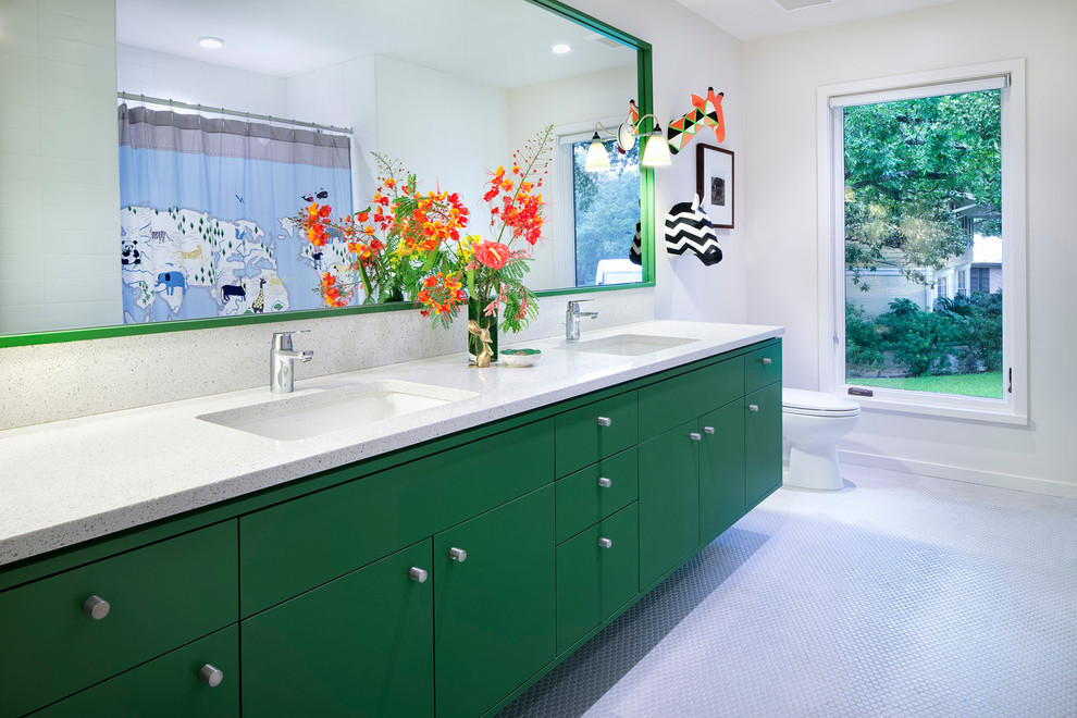 Design ideas for a mid-sized contemporary kids bathroom in Austin with an undermount sink, flat-panel cabinets, green cabinets, solid surface benchtops, white tile, mosaic tile, white walls and mosaic tile floors.