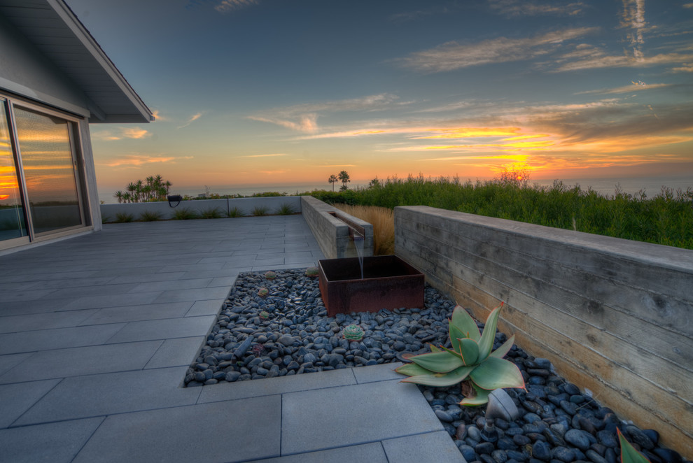 Inspiration for a large contemporary backyard patio in Orange County with no cover and concrete pavers.