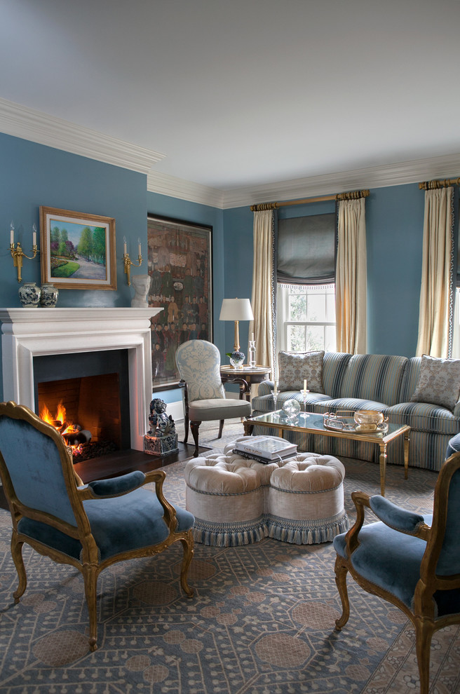 Mid-sized traditional enclosed living room in New York with blue walls, dark hardwood floors, a standard fireplace and no tv.