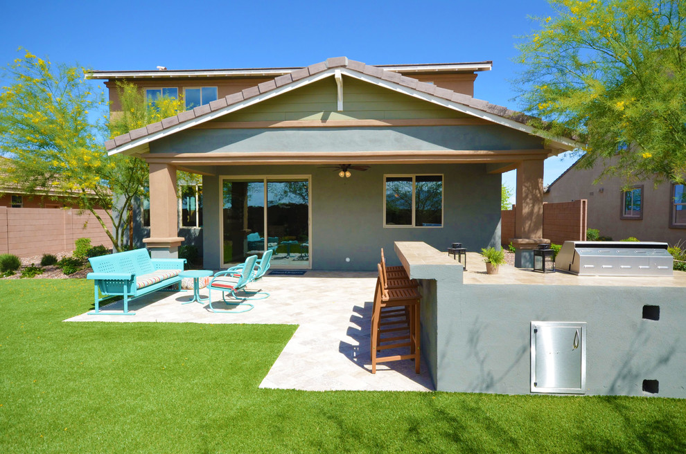 This is an example of a mid-sized contemporary backyard patio in Phoenix with an outdoor kitchen and brick pavers.