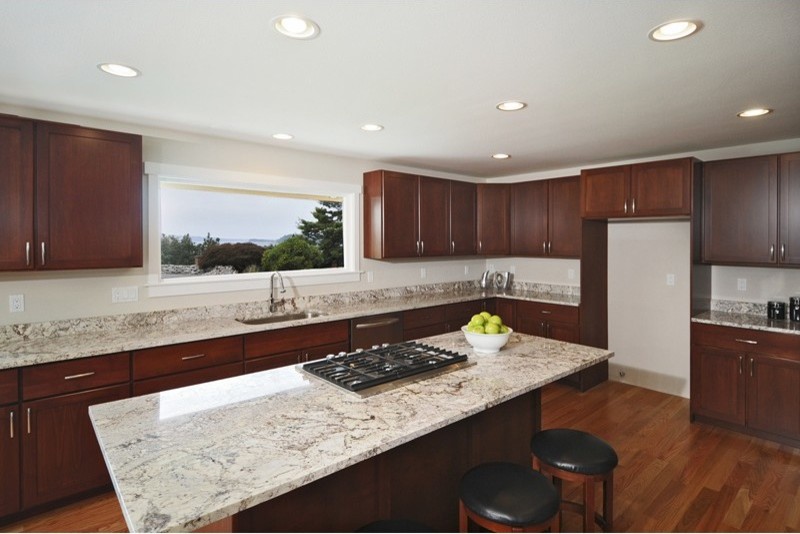 Large transitional u-shaped medium tone wood floor eat-in kitchen photo in Seattle with an undermount sink, flat-panel cabinets, dark wood cabinets, laminate countertops and an island