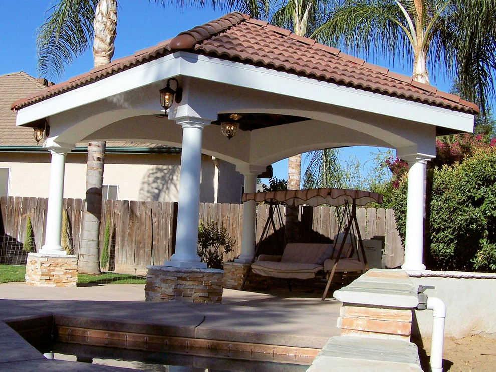 Photo of a mid-sized mediterranean backyard patio in Other with concrete slab and a gazebo/cabana.