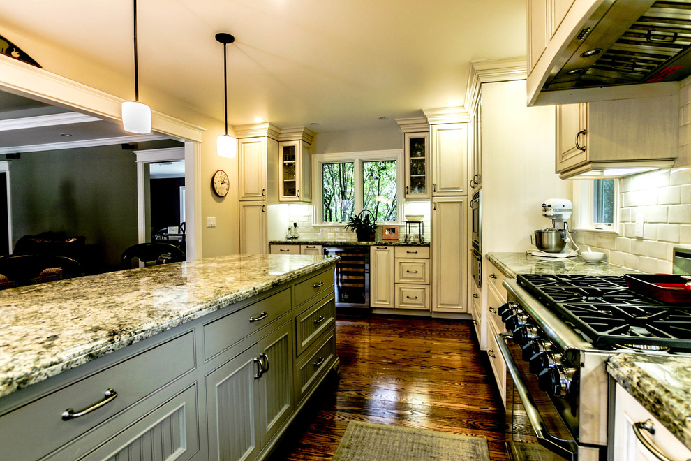 Traditional u-shaped eat-in kitchen in San Francisco with a farmhouse sink, beaded inset cabinets, granite benchtops and stainless steel appliances.
