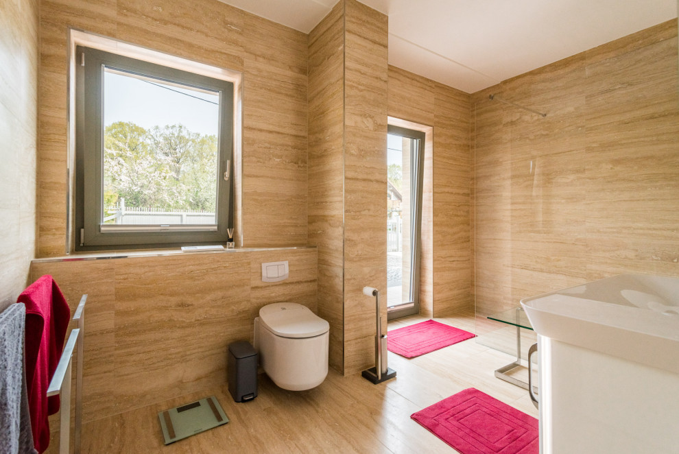 Large contemporary 3/4 bathroom in Leipzig with white cabinets, a curbless shower, a wall-mount toilet, limestone, limestone floors, beige floor, white benchtops, a single vanity and wallpaper.
