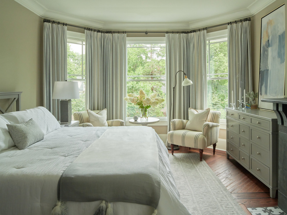 This is an example of a transitional guest bedroom in New York with beige walls, dark hardwood floors and brown floor.