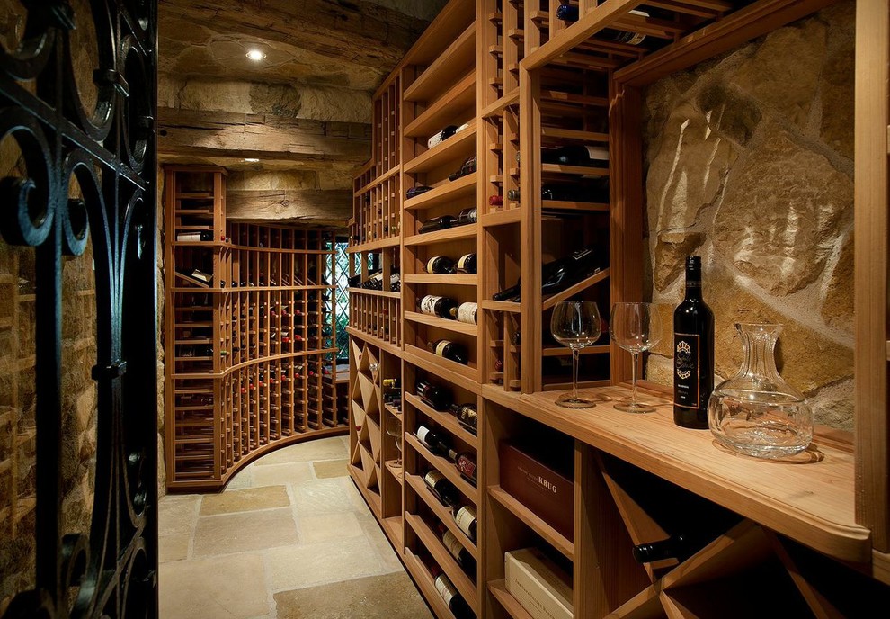 Photo of a mediterranean wine cellar in Phoenix with storage racks and beige floor.