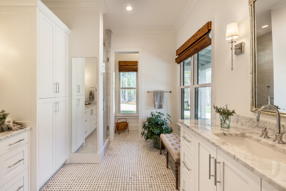 Photo of a mid-sized country master bathroom in Other with recessed-panel cabinets, white cabinets, gray tile, white walls, an undermount sink, marble benchtops, grey floor, a hinged shower door, white benchtops, porcelain tile and marble floors.
