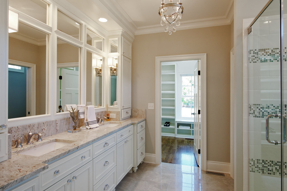 Inspiration for a large traditional master bathroom in Other with beaded inset cabinets, white cabinets, an alcove shower, a two-piece toilet, beige tile, stone slab, beige walls, porcelain floors, an undermount sink, granite benchtops, beige floor and a hinged shower door.