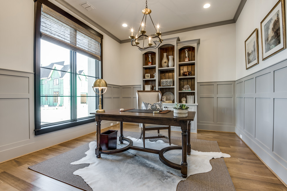 Mid-sized country study room in Dallas with white walls, dark hardwood floors, a freestanding desk and brown floor.