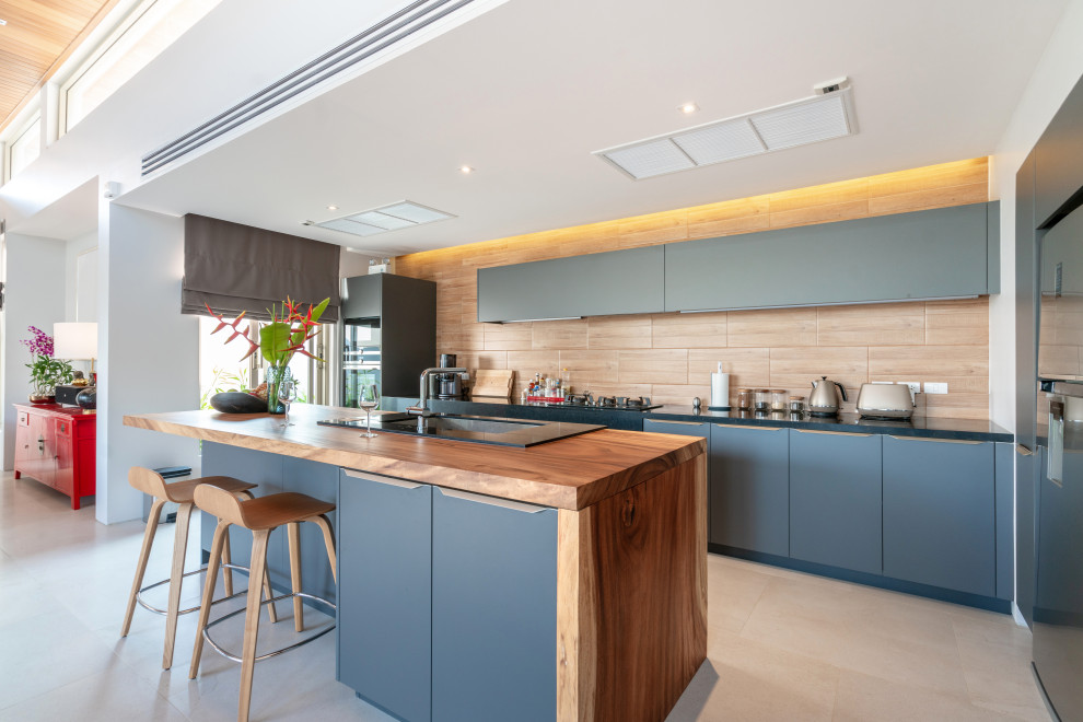 Large modern galley eat-in kitchen in San Francisco with a drop-in sink, flat-panel cabinets, blue cabinets, wood benchtops, brown splashback, panelled appliances, cement tiles, with island, brown floor, green benchtop and coffered.