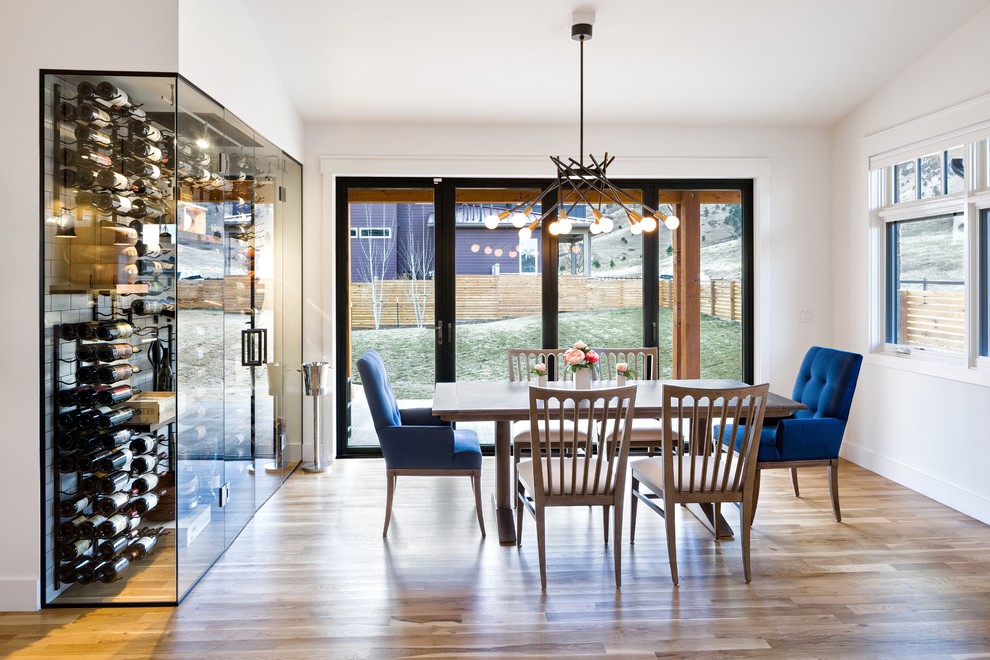 Mid-sized transitional open plan dining in Denver with white walls, light hardwood floors and brown floor.