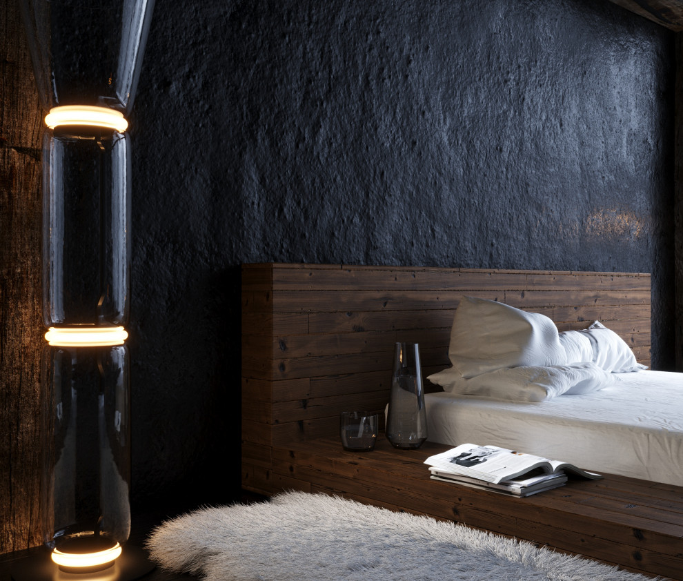 Inredning av ett modernt mellanstort sovloft, med svarta väggar, mörkt trägolv, en hängande öppen spis, en spiselkrans i metall och svart golv