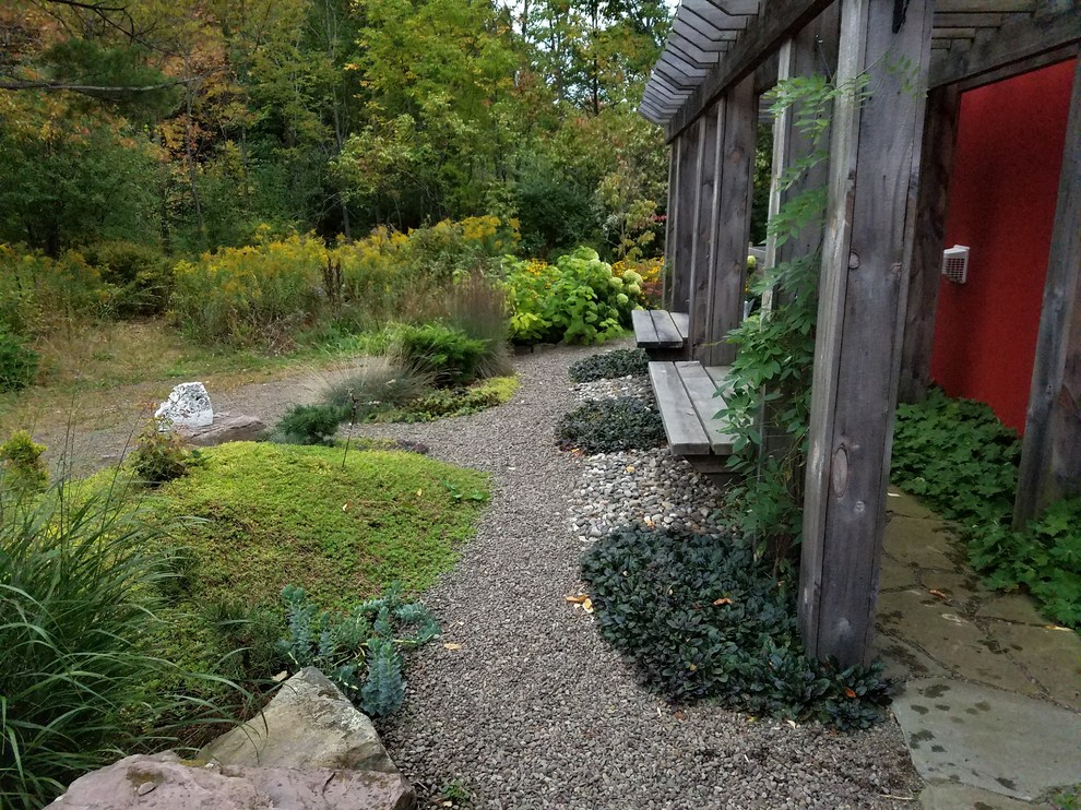 Large asian backyard partial sun xeriscape in New York with a garden path and natural stone pavers.