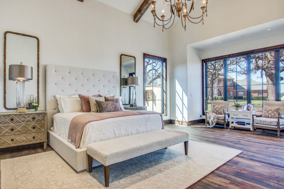 This is an example of a transitional master bedroom in Dallas with yellow walls, medium hardwood floors, no fireplace, brown floor and exposed beam.
