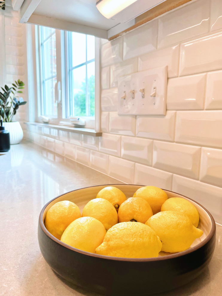 Large transitional u-shaped ceramic tile and beige floor open concept kitchen photo with an undermount sink, recessed-panel cabinets, white cabinets, quartz countertops, white backsplash, ceramic backsplash, stainless steel appliances, an island and gray countertops