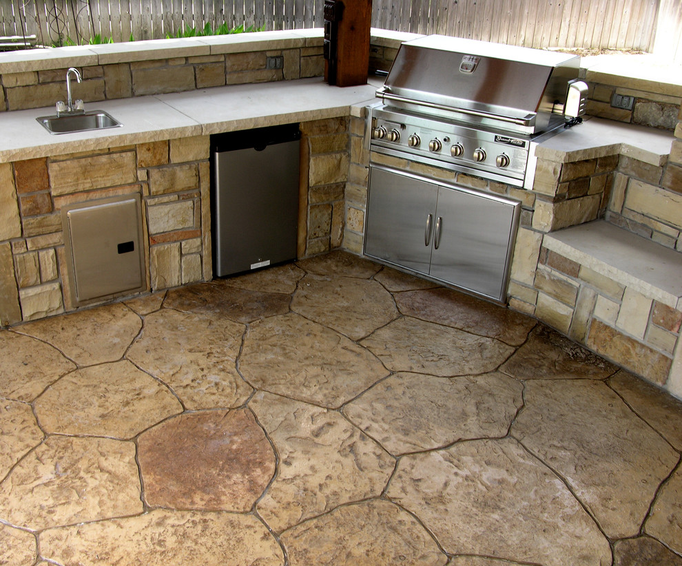Photo of a mid-sized traditional backyard patio in Dallas with an outdoor kitchen, stamped concrete and a gazebo/cabana.