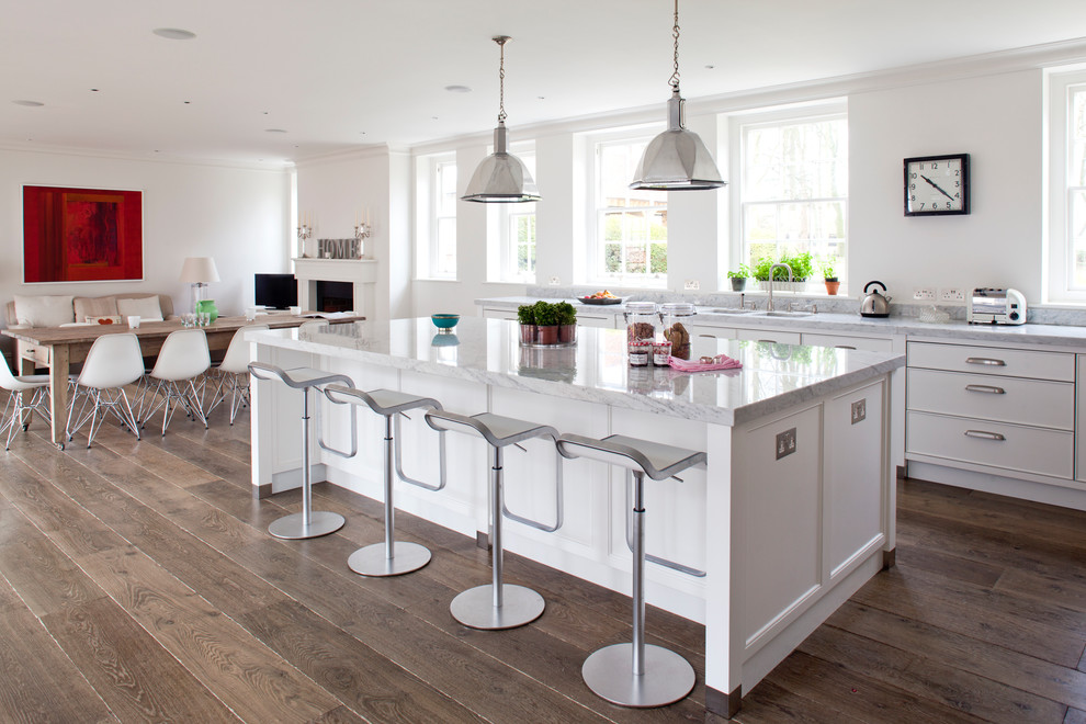 Inspiration for a traditional eat-in kitchen in Wiltshire with flat-panel cabinets, white cabinets and marble benchtops.