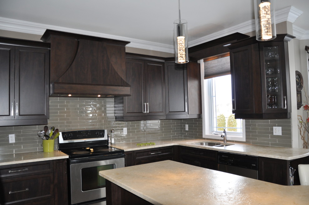 Example of a large transitional u-shaped ceramic tile open concept kitchen design in Ottawa with an undermount sink, shaker cabinets, dark wood cabinets, granite countertops, beige backsplash, glass tile backsplash, stainless steel appliances and an island