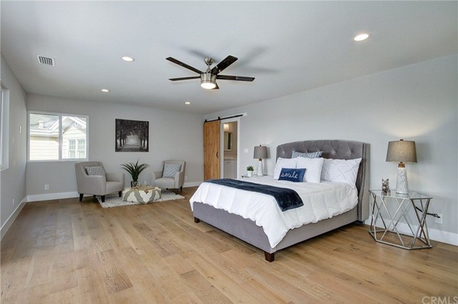 Example of a transitional bedroom design in Orange County