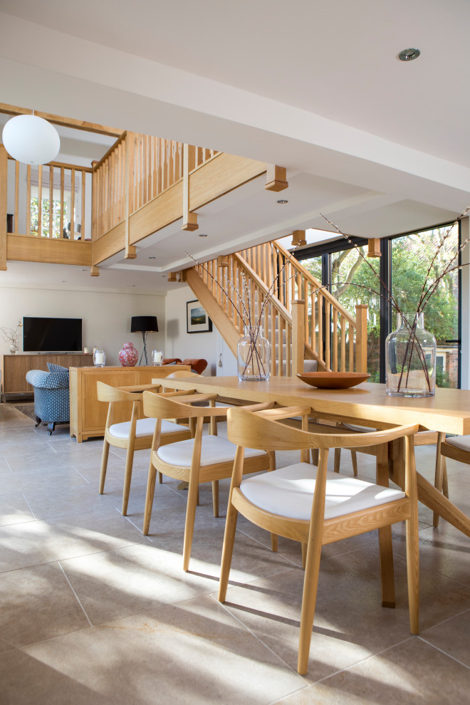 Inspiration for a large contemporary open plan dining in Other with white walls, limestone floors, no fireplace, beige floor and exposed beam.