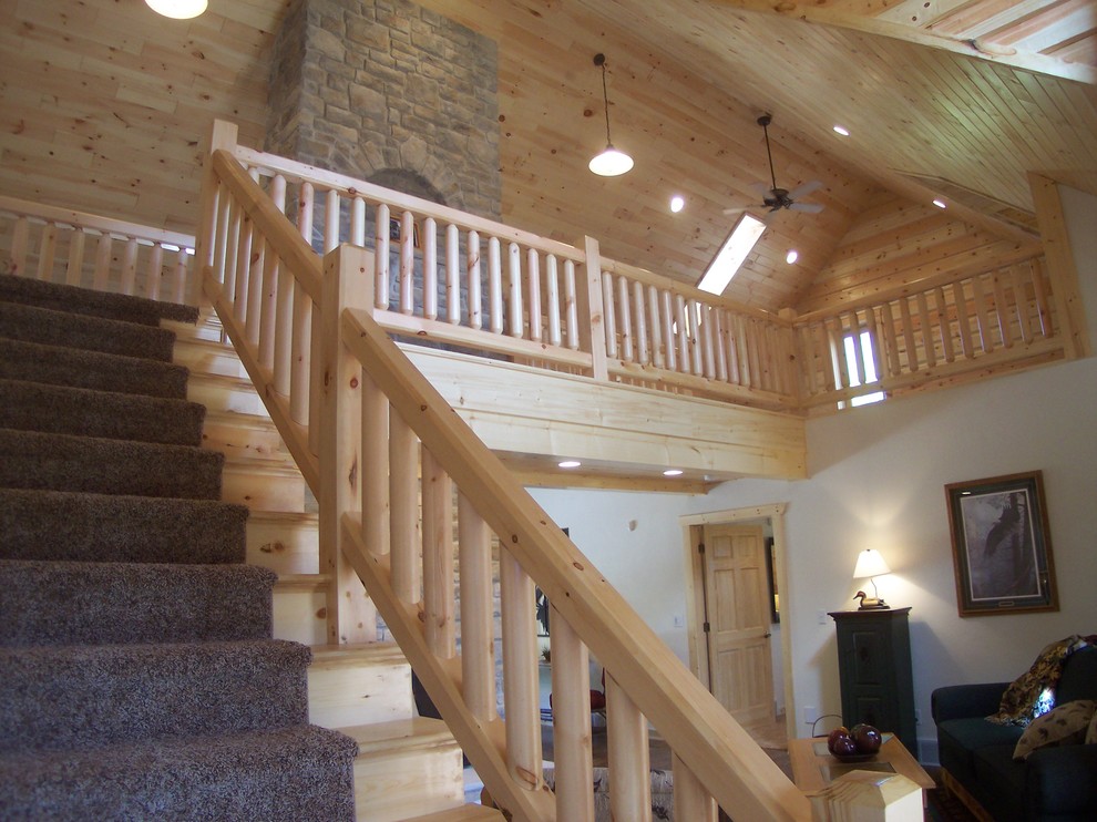 Mid-sized mountain style carpeted straight wood railing staircase photo with carpeted risers
