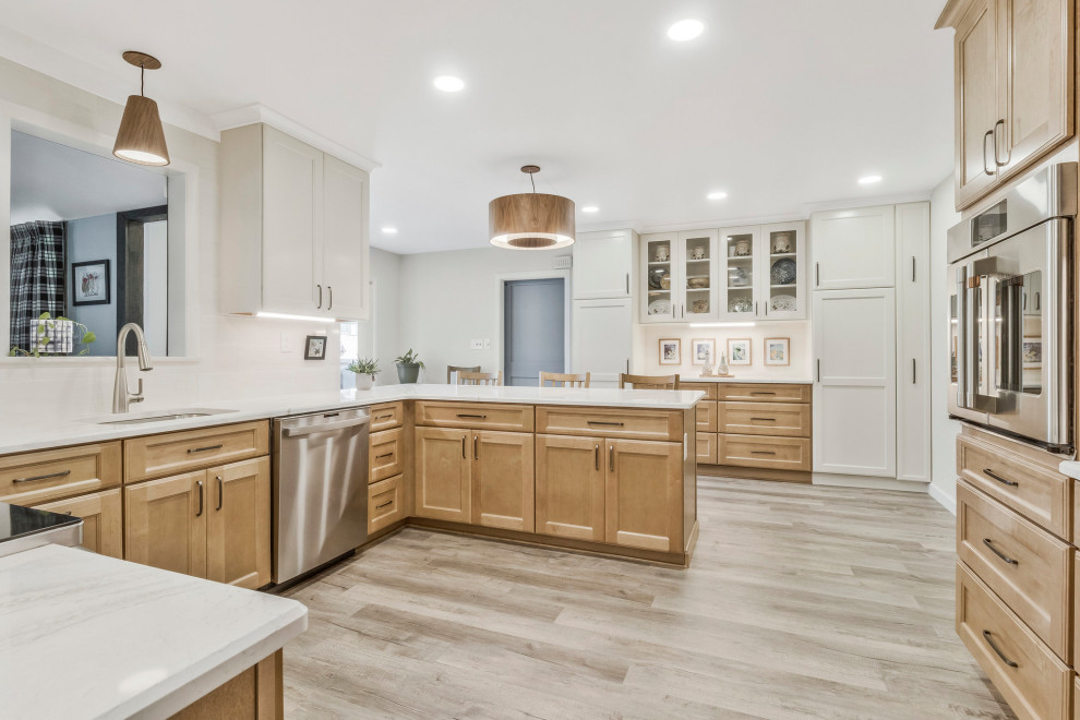 Example of a huge transitional u-shaped kitchen pantry design in DC Metro with an undermount sink, recessed-panel cabinets, quartz countertops, white backsplash, subway tile backsplash, stainless steel appliances, a peninsula and white countertops