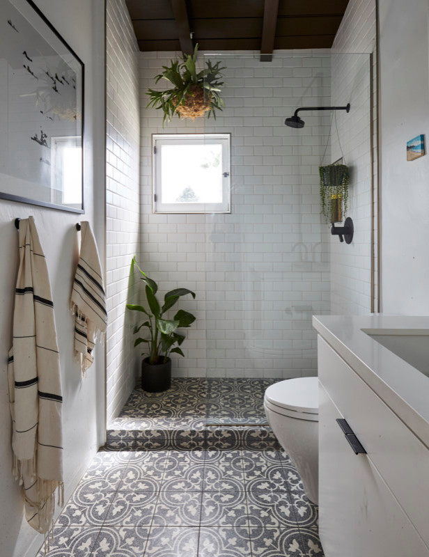 Inspiration for a master bathroom in Orange County with flat-panel cabinets, white cabinets, an open shower, white tile, ceramic tile, cement tiles, an undermount sink, engineered quartz benchtops, black floor and white benchtops.