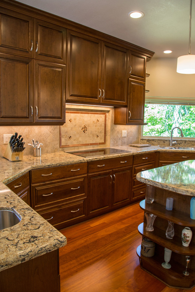 Traditional u-shaped kitchen in Sacramento with an undermount sink, raised-panel cabinets, brown cabinets, quartz benchtops, beige splashback, white appliances, medium hardwood floors and with island.