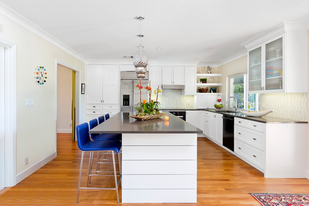 Inspiration for a contemporary l-shaped kitchen in Miami with shaker cabinets, white cabinets, quartz benchtops, glass tile splashback, medium hardwood floors and with island.