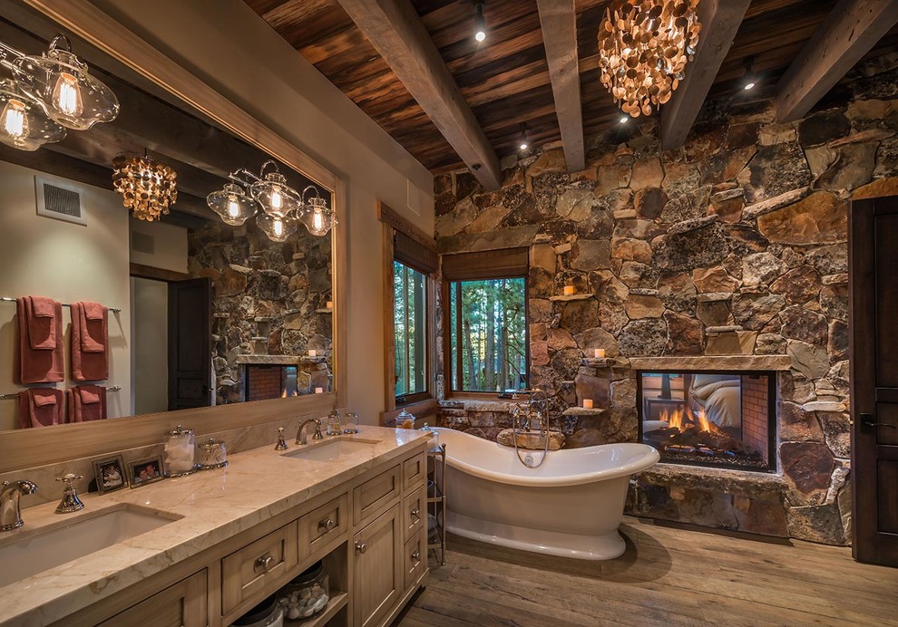 Design ideas for a country bathroom in Sacramento with an undermount sink, shaker cabinets, medium wood cabinets, a freestanding tub, beige walls and medium hardwood floors.