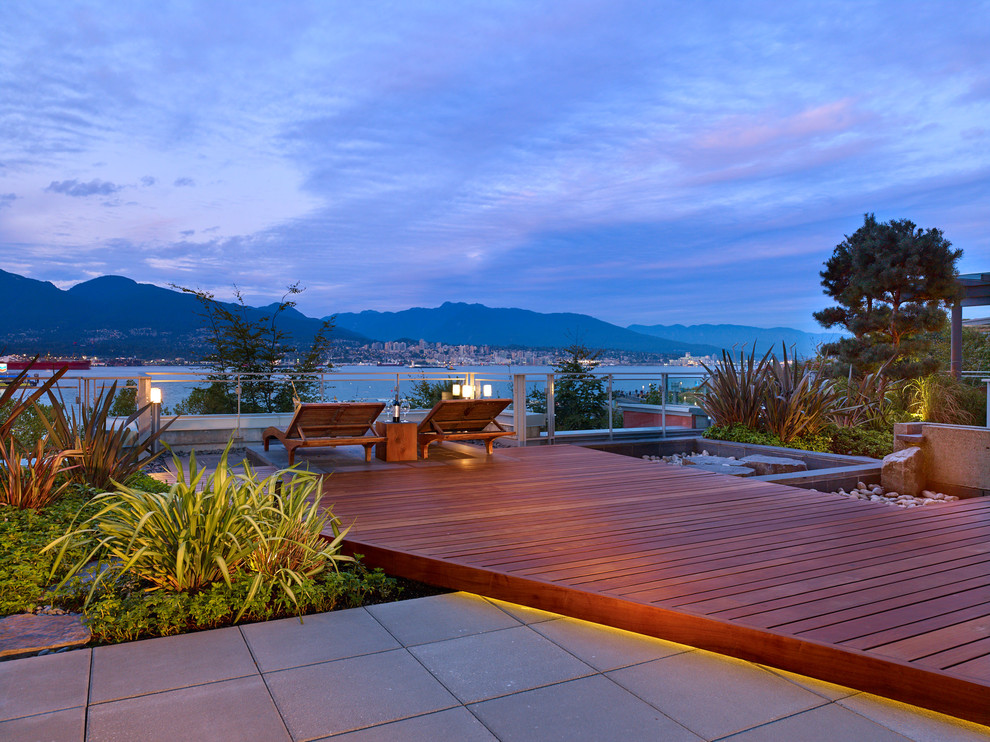 Large contemporary courtyard deck in Vancouver with a fire feature and no cover.