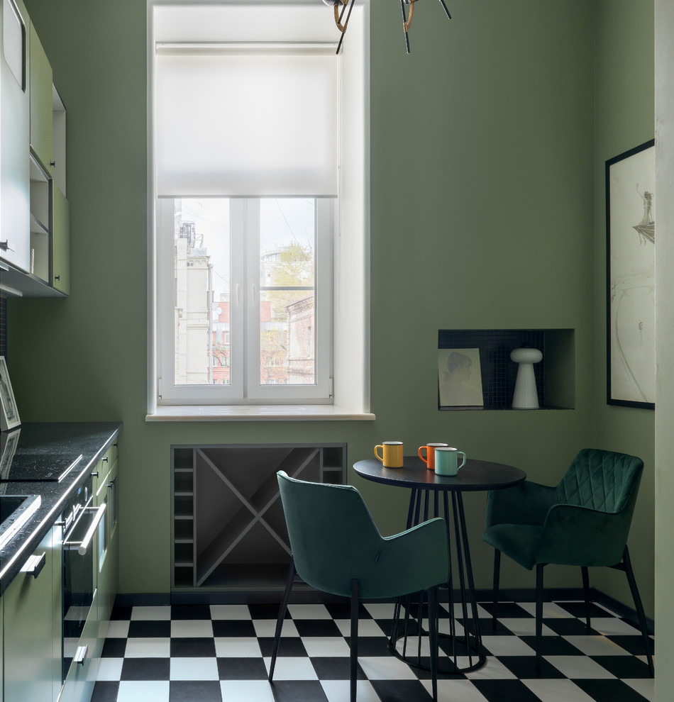 Design ideas for a small eclectic single-wall separate kitchen in Moscow with flat-panel cabinets, green cabinets, granite benchtops, porcelain floors, black benchtop, multi-coloured floor, a drop-in sink, black appliances and no island.
