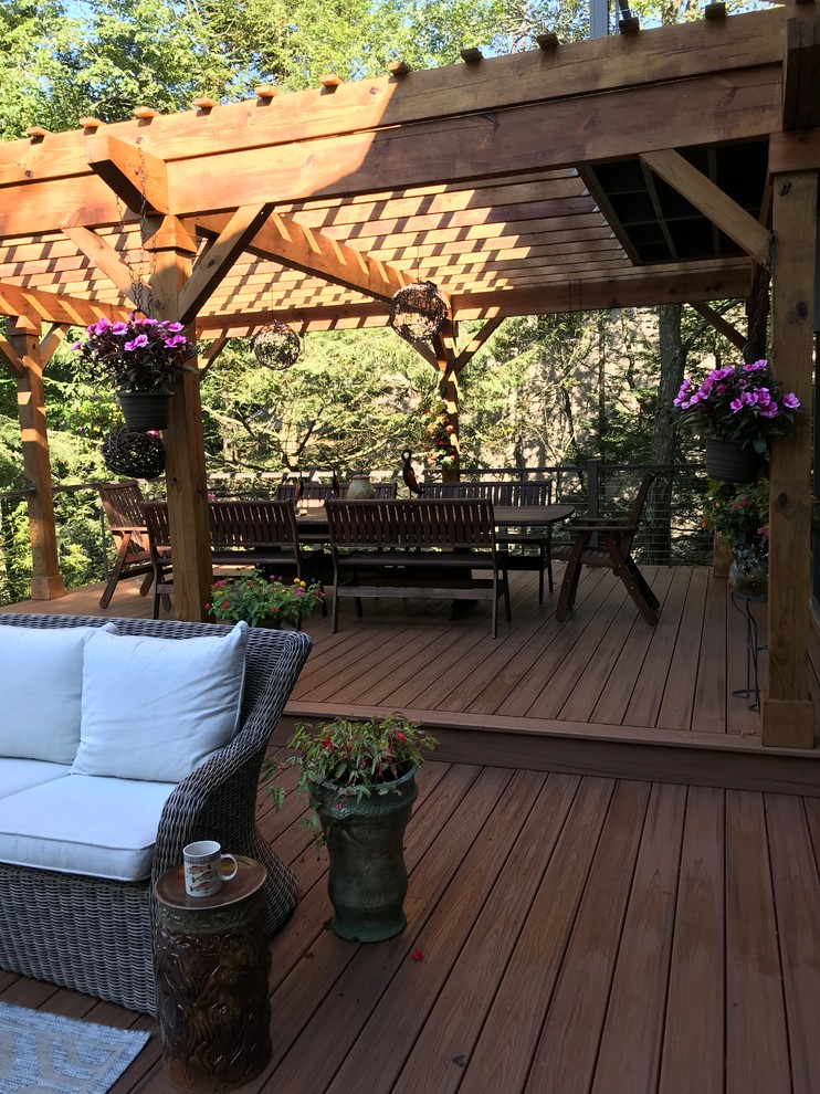 Design ideas for a transitional backyard deck in Other with a pergola.