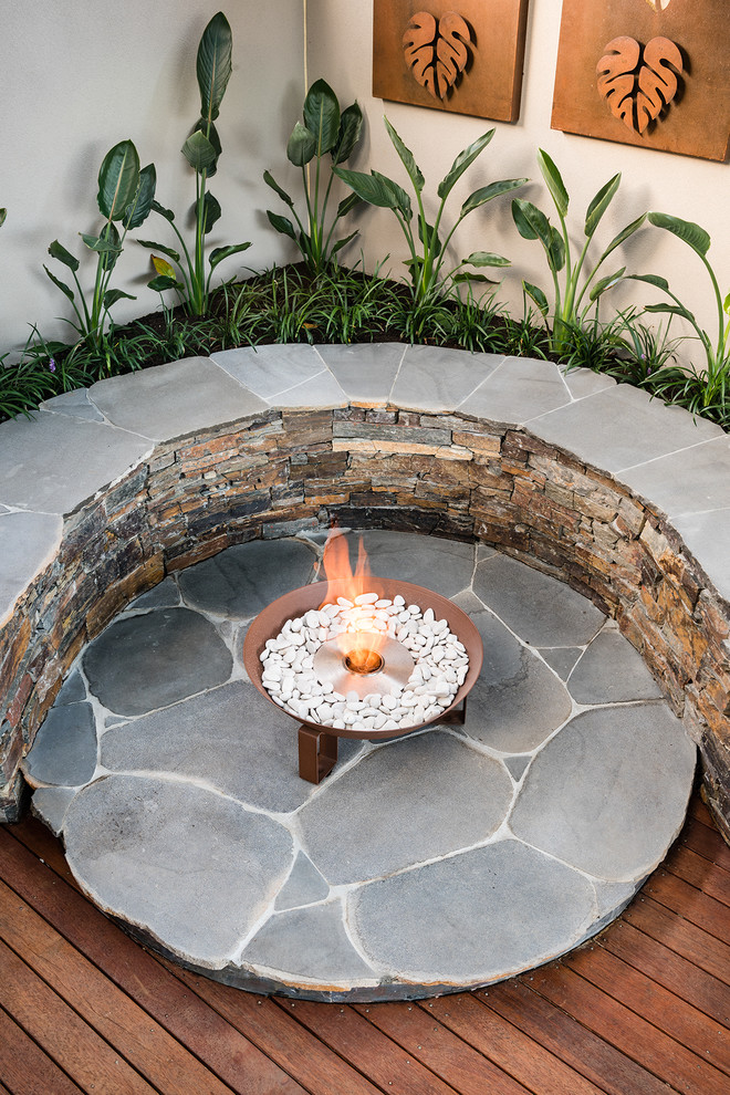 Design ideas for a mid-sized contemporary backyard deck in Melbourne with a fire feature.