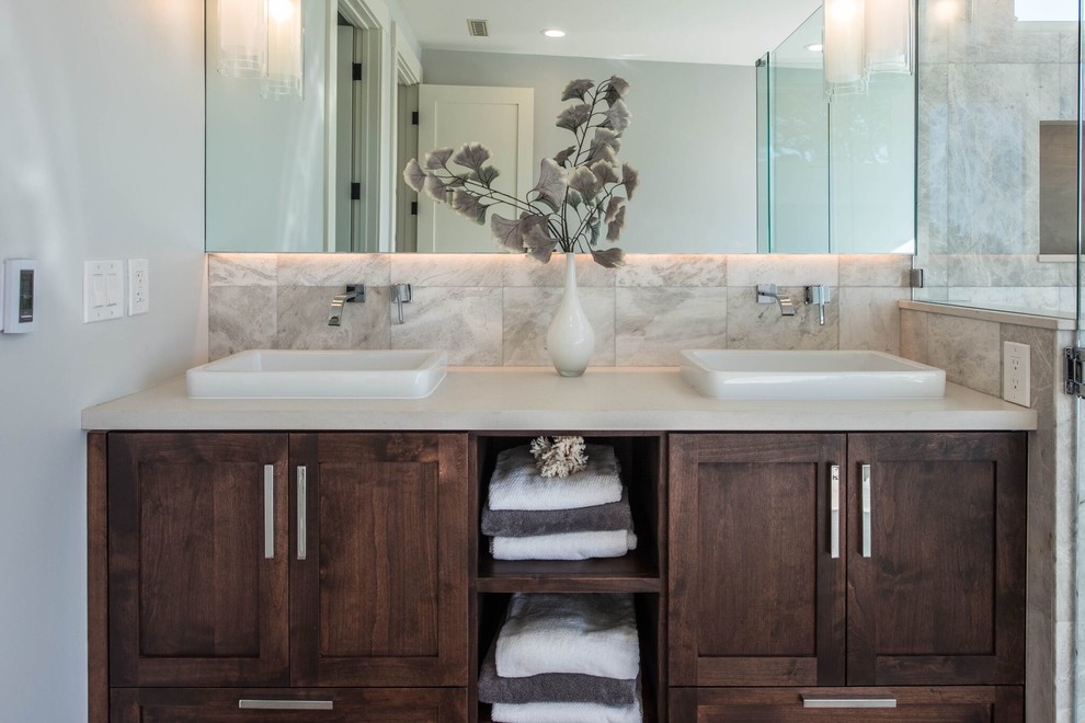 Example of a large transitional master porcelain tile porcelain tile freestanding bathtub design in Orange County with shaker cabinets, dark wood cabinets, gray walls and a vessel sink