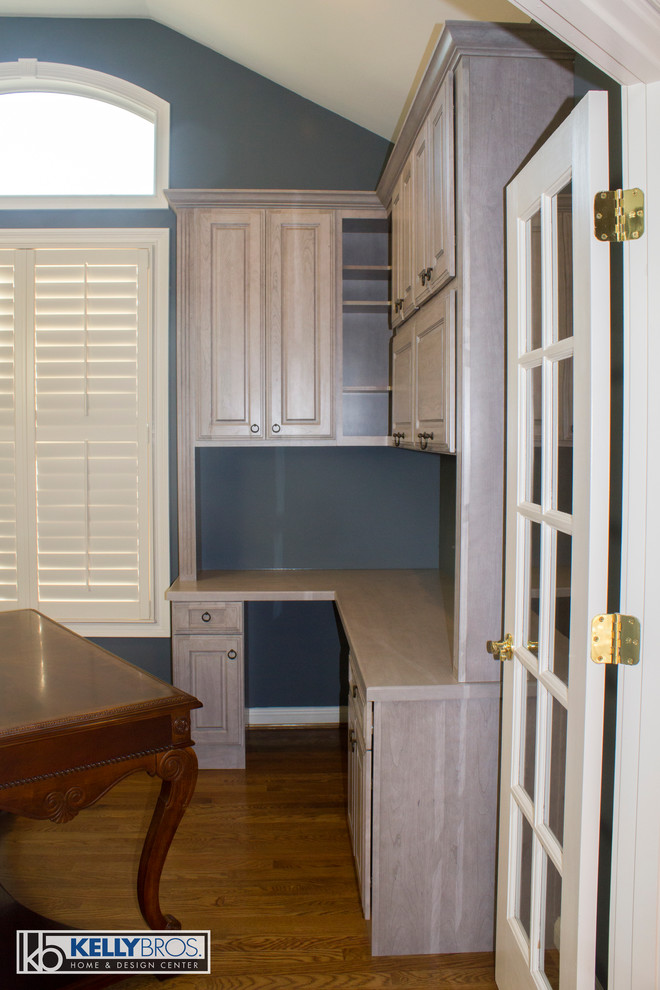 Study room - large transitional built-in desk medium tone wood floor study room idea in Cincinnati with gray walls