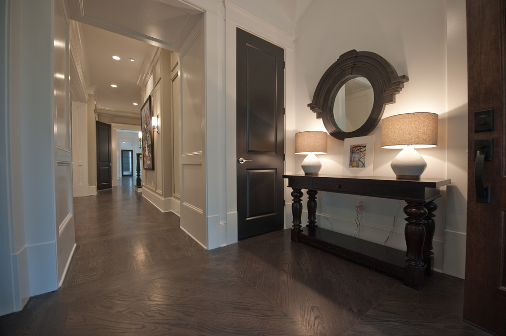 Mid-sized transitional foyer in Atlanta with a single front door, a dark wood front door, white walls and dark hardwood floors.