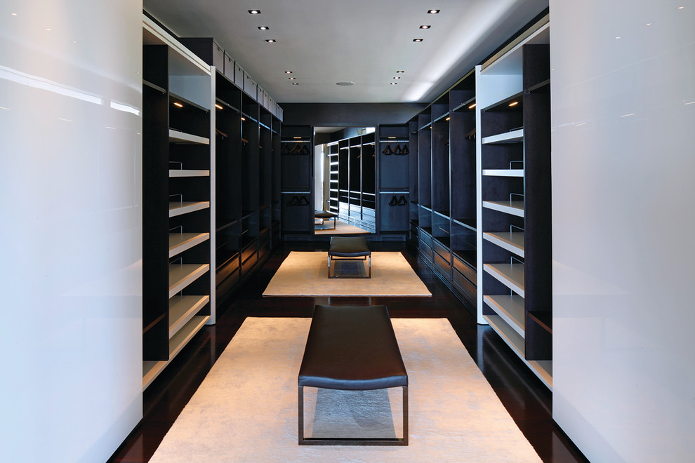 Inspiration for an expansive modern gender-neutral dressing room in Los Angeles with open cabinets, dark wood cabinets, brown floor and recessed.