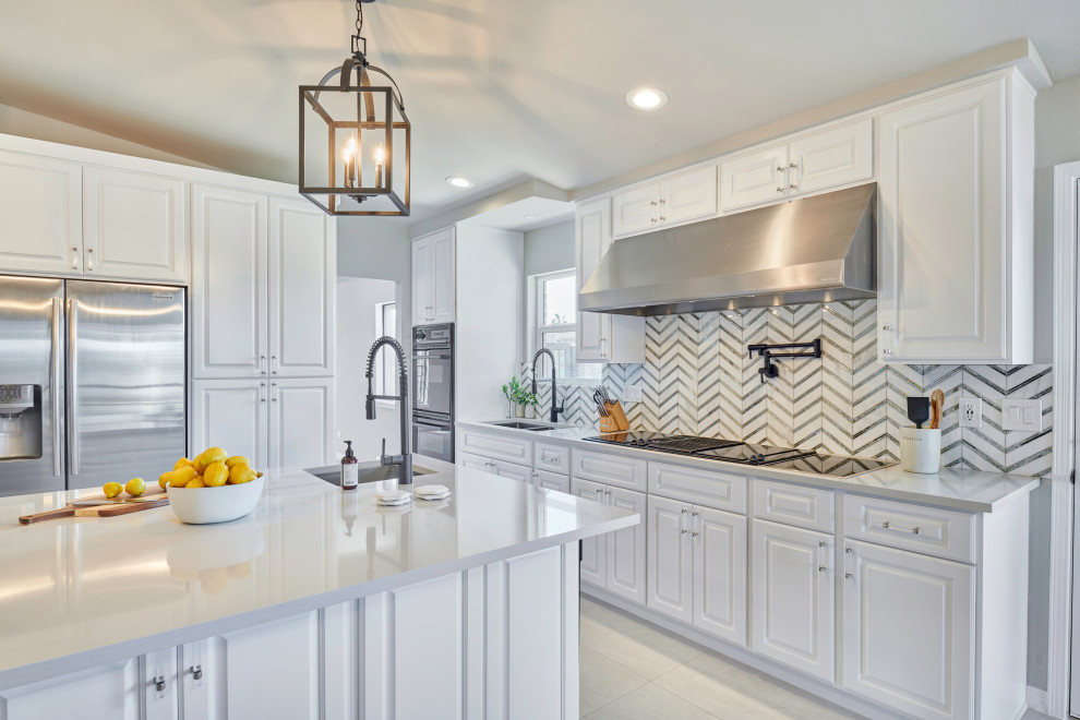 Small transitional l-shaped porcelain tile and gray floor eat-in kitchen photo with an undermount sink, beaded inset cabinets, white cabinets, quartzite countertops, multicolored backsplash, glass sheet backsplash, black appliances, a peninsula and white countertops
