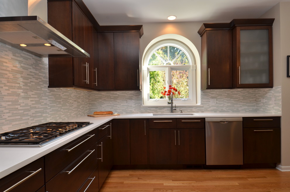 Eat-in kitchen - mid-sized transitional l-shaped light wood floor eat-in kitchen idea in Chicago with an undermount sink, flat-panel cabinets, dark wood cabinets, quartzite countertops, multicolored backsplash, matchstick tile backsplash, stainless steel appliances and an island