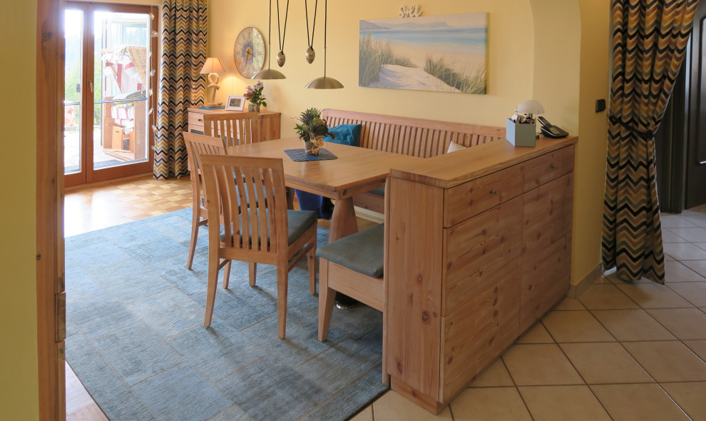 This is an example of a beach style dining room with yellow walls, carpet and blue floor.
